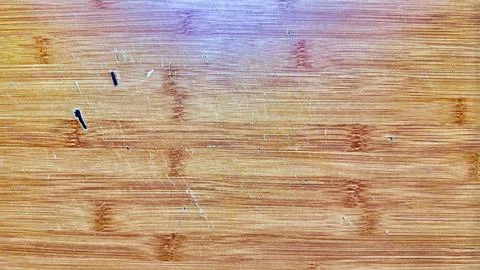 Weathered bamboo cutting board texture surface showing natural wood grain kni Stock Photos