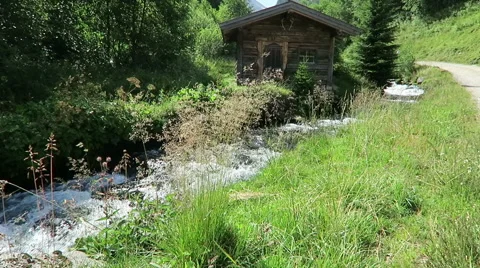 Weathered barn on a small stream in European alps. Schwarzachtal valley  Video stock 67569987