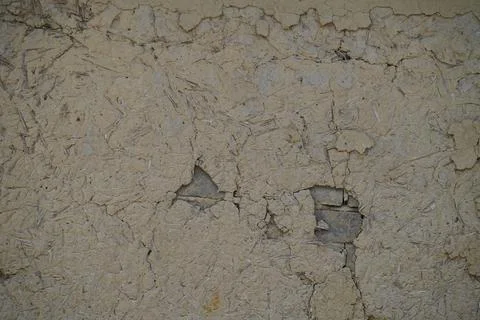 Weathered beige concrete wall texture with cracks and peeling paint surface back Stock Photos