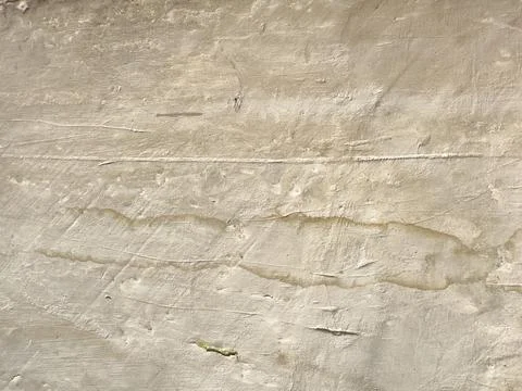 Weathered beige plaster wall texture with cracks and stains, rustic grunge .. Stock Photos