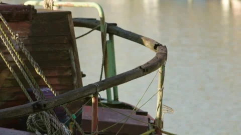 Weathered boat railing with ropes and wooden details by calm water Stock Footage 325954319