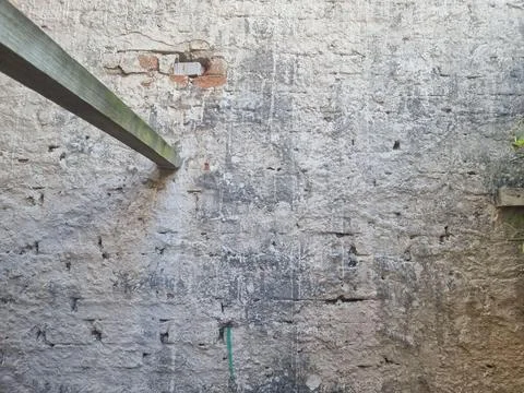 Weathered brick wall with beam Stock Photos