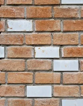 Weathered brick wall with blank white ceramic tiles Stock Photos