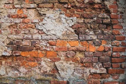 Weathered Brick Wall With Peeling Paint background Stock Photos