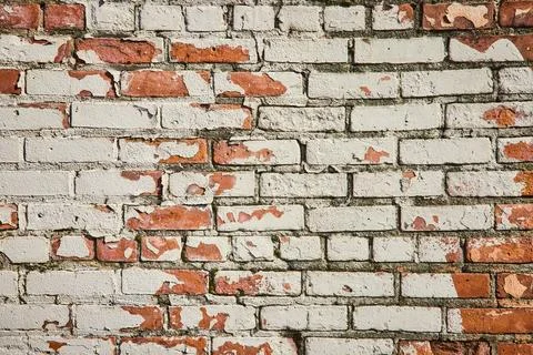 Weathered Brick Wall with Peeling Paint Texture Eye-Level View Stock Photos