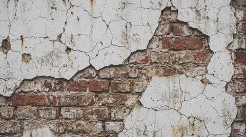 Weathered brick wall with peeling paint. Fotos Stock