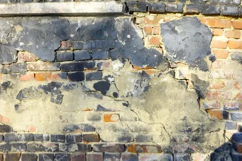 A Weathered Brick Wall With Peeling Paint Reveals Layers of History and Tex.. Stock Photos