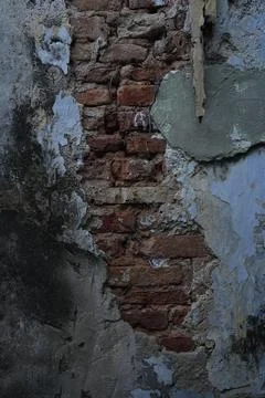 Weathered brick wall with peeling plaster Foto stock