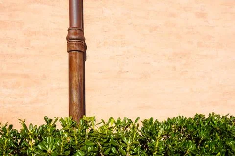 Weathered brick wall with pipe gutter. Detail of the facade of a house Stock Photos