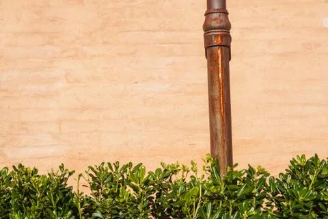 Weathered brick wall with pipe gutter. Detail of the facade of a house Stock Photos