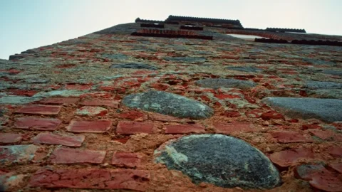 Weathered brick wall rising against a clear sky Stock Footage 301125331