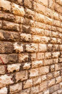 Weathered brick wall texture with warm reddish tones and natural aging pattern Stock Photos