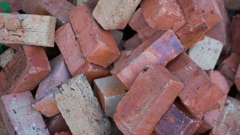 Weathered Bricks Pile Background, Building materials Stock Photos