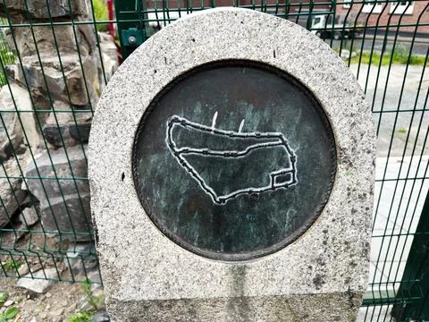 Weathered bronze map plaque set in a stone marker by a fence in Dublin, Ire.. Stock Photos