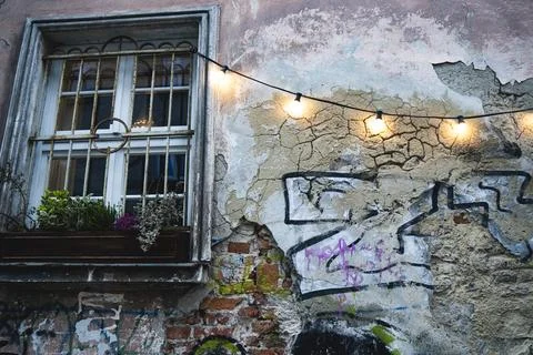 Weathered building facade with string lights, Kazimierz district, Kraków Stock Photos