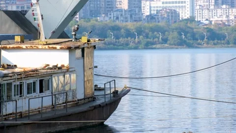 A weathered cargo vessel sits moored along the Liujiang River in Liuzhou, China Vídeos de archivo 296084427