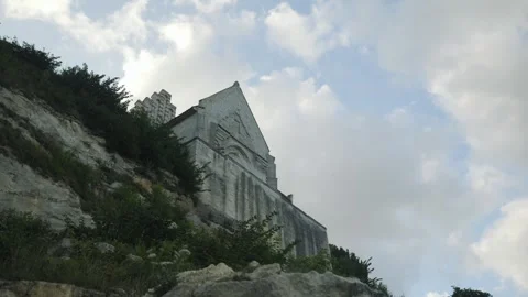 Weathered Chapel High Above Rugged Terrain. Secluded Stone Church Surrounded By Stock Footage 345500008