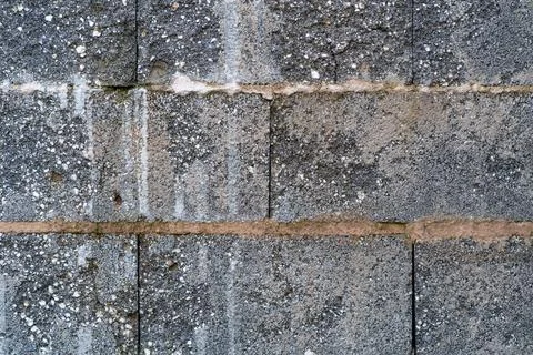 Weathered concrete block wall texture with rough masonry surface 写真素材