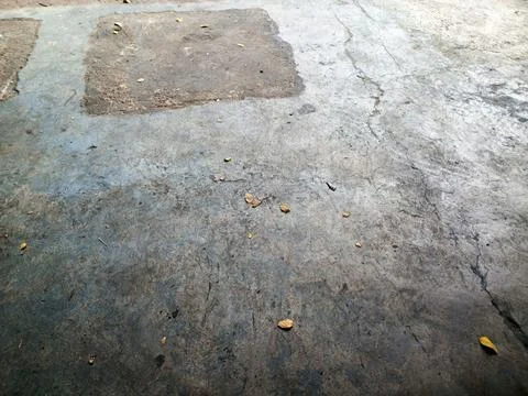 Weathered Concrete Floor Texture With Surface Cracks And Patch Repair 写真素材
