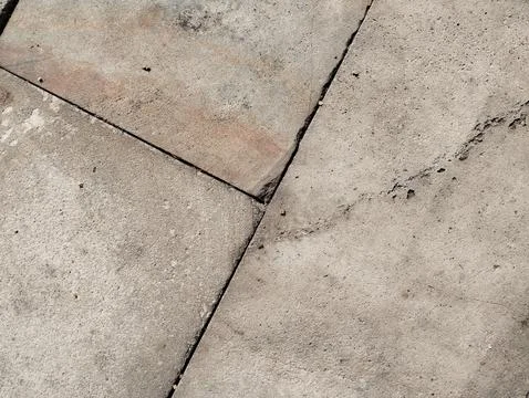 Weathered Concrete Pavement Texture with Cracks and Geometric Patterns Stock Photos