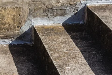 Weathered concrete steps in harsh sunlight - diagonal closeup. Stock Photos