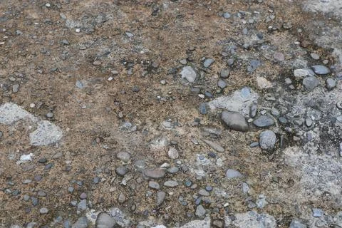 Weathered Concrete Surface with Embedded Pebbles and Organic Stains Texture Stock Photos