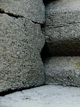 Weathered concrete surface, showcasing the rough texture, cracks, and shado.. Stock Photos