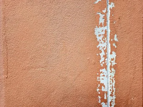 Weathered Concrete Wall Featuring Brown Peeling Paint and Visible Cracks. Stock Photos