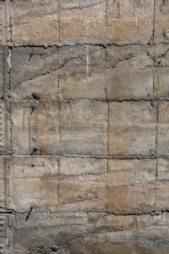 Weathered Concrete Wall Texture with Cracks and Metal Protrusions Photos