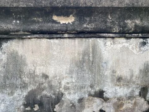 Weathered concrete wall texture with dark mold spots. 스톡 사진