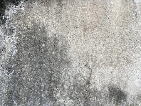 Weathered concrete wall texture with dark mold spots. Stockfoto's