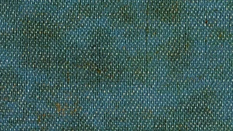 Weathered denim fabric texture with stains and wear depicted horizontally Stock Footage 340237134