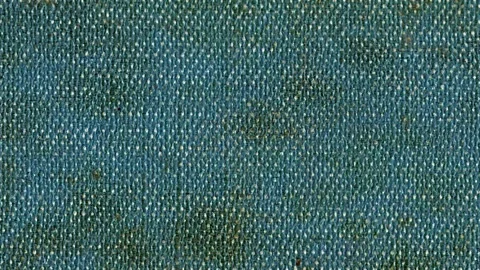 Weathered denim fabric texture with stains and wear depicted vertically Stock Footage 340237136