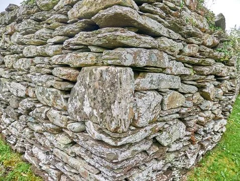 Weathered dry stone wall built from stacked rocks Stock Photos