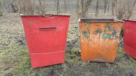 A weathered dumpster, overflowing and filled with waste, showcases the grim Stock Footage 305279229