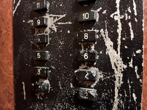 Weathered elevator button panel with floor numbers Stock Photos