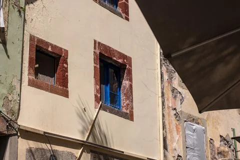 Weathered facade with basalt framed windows in Funchal, Madeira Stock Photos