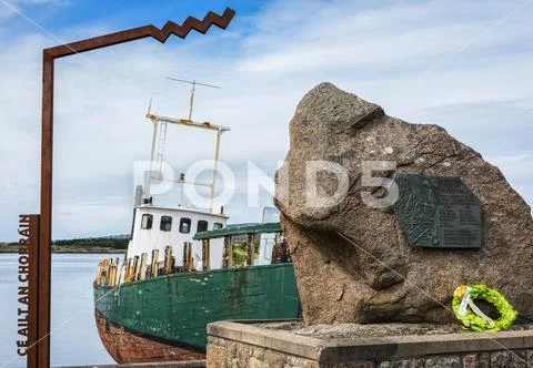 A weathered fishing boat moored at the waterfront Stock Photos