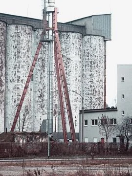 Weathered grain silos with red support beams Stock Photos
