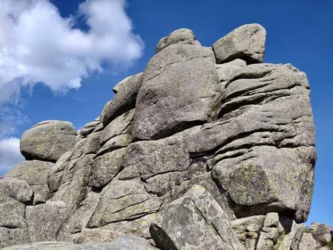 Weathered granite rock formation under a blue sky Stock Photos