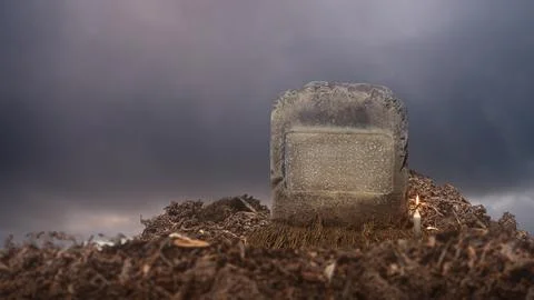 Weathered gravestone with dark cloud background. The scene is scary and mys.. Stock Photos