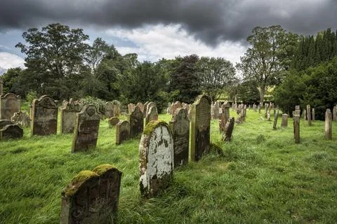 Weathered gravestones in the old graveyard of the monastic ruins of Lanercost Stock Photos