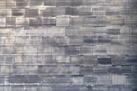 Weathered gray stone tile wall with rectangular patterns and varied shading.. Stock Photos