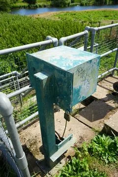 Weathered Green Control Box By River Fence, Nottinghamshire, England Stock Photos