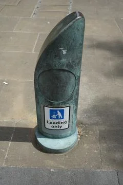 Weathered Green Loading Only Bollard Sign On Sidewalk In Sheffield, England Fotos de archivo