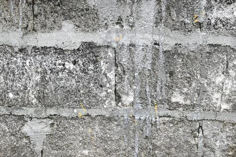 Weathered grey brick wall with peeling paint and texture 写真素材