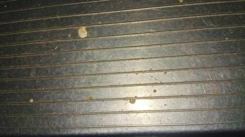 Weathered grey metal surface with horizontal lines and dirty spots Stock Photos
