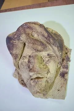 Weathered handmade sculpted face in close-up Stock Photos