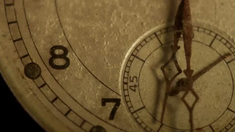 Weathered hands tick slowly over an antique watch face Stock Footage 329595844