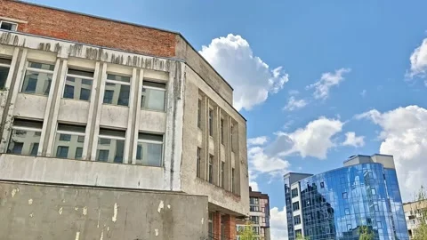 Weathered Historic Building Facade Contrasting with Modern Glass 動画素材 343705499